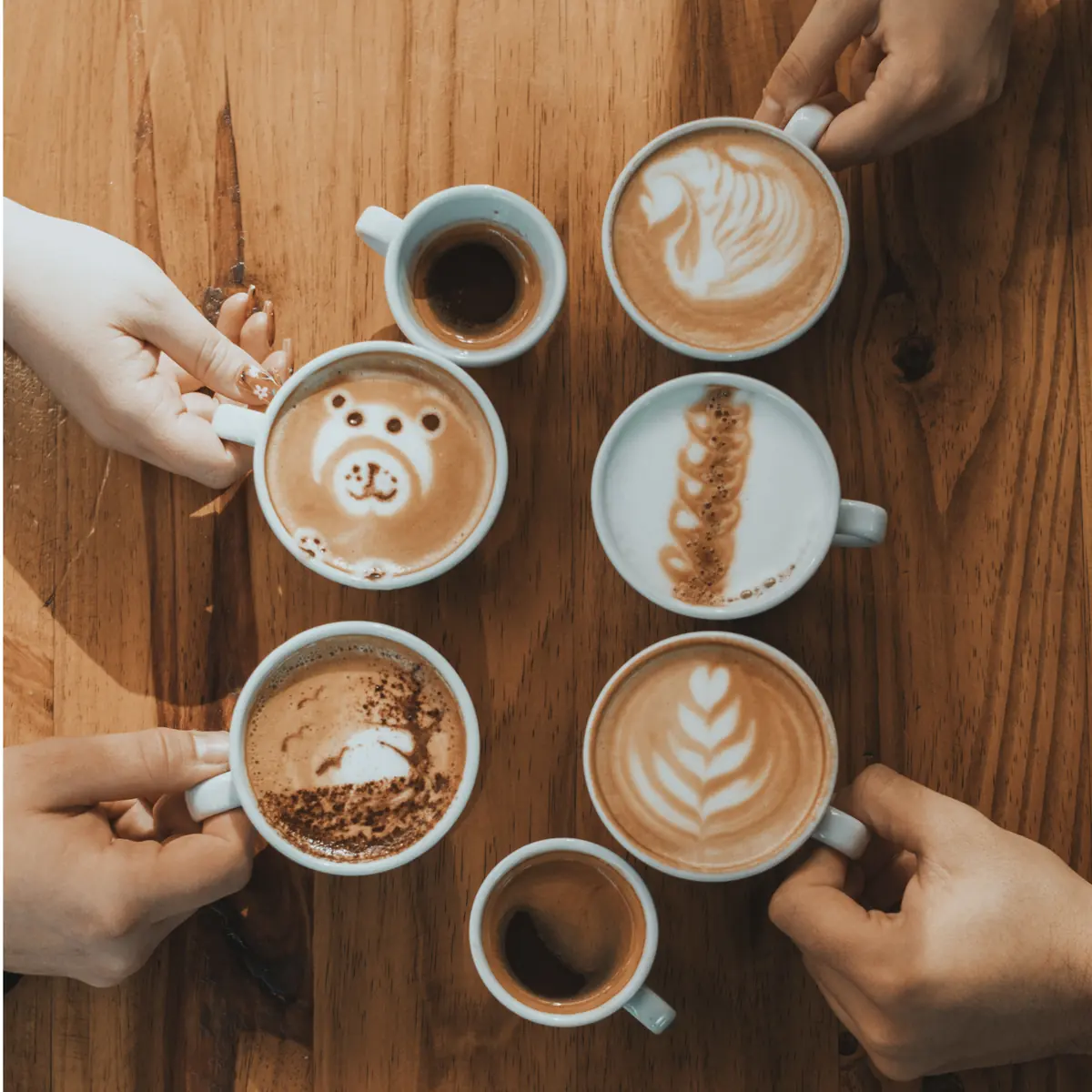 Friends sharing coffees with latte art